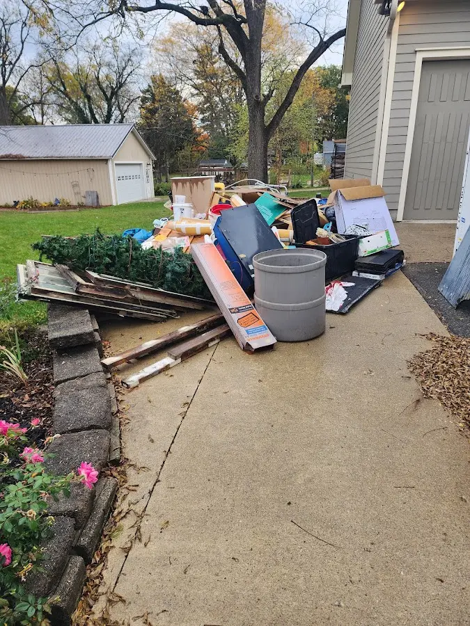 Dumpster being loaded with debris for Residential Dumpster Rental in Henderson